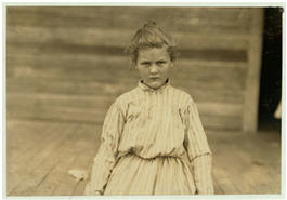 A young girl of about nine or ten years of age staring into the camera.