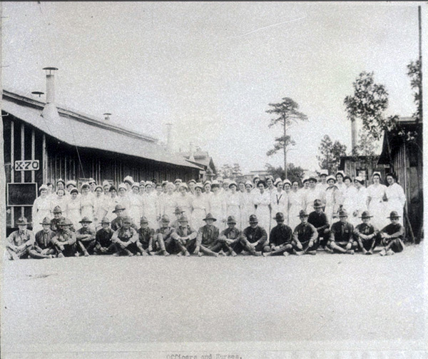 Uniformed nurses and military men pose in front of Camp Jackson in South Carolina, 1918.