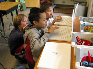 Fifth-graders (from left) Reese Toomre, Lucas Nguyen and Michael An race through the Khan  Academy's Trigonometry Challenge. The program allows more advanced students to  move ahead, while other students can proceed at their own pace.
