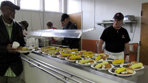 Steven White (right) helps serve dinner at the Salvation Army soup kitchen.