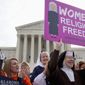 Nuns and their supporters rally outside the Supreme Court in Washington, Wednesday, March 23, 2016, as the court hears arguments to allow birth control in healthcare plans in the Zubik vs. Burwell case. The Supreme Court seems deeply divided over the arrangement devised by the Obama administration to spare faith-based groups from having to pay for birth control for women covered under their health plans. (AP Photo/Jacquelyn Martin)