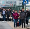 People walk away from Brussels airport after Tuesday's terrorist attack. Analysts say the violence may reduce travel for a while but the industry should bounce back.