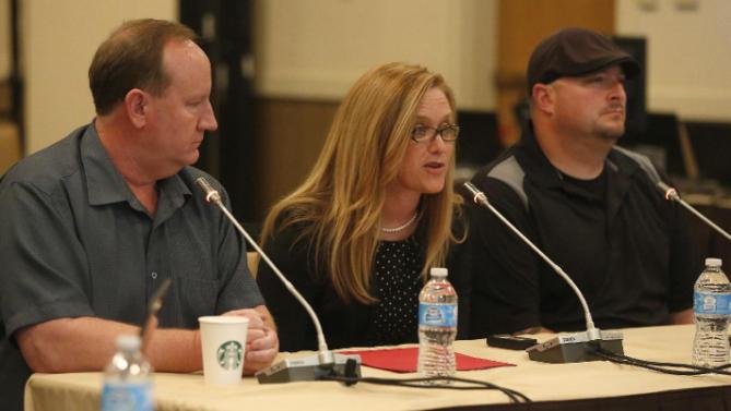 From left, Woods Cross Police Department chief Greg Butler, Jenn Oxborrow of the Utah Department of Human Services, and Sgt. Adam Osoro of the Woods Cross Police Department testify at the Utah public meeting on Tuesday, May 19, 2015 in Salt Lake City.  (Jim Urquhart/AP Images for CECANF)