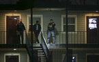 Police investigators with a man who was in one of the rooms at the Mid...