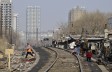 A shanty town in Shenyang, Liaoning Province, where residents will move into low-rent apartments provided by the government, on March 11, 2009. High-rise apartments are seen in the distance. (China Photos/Getty Images)