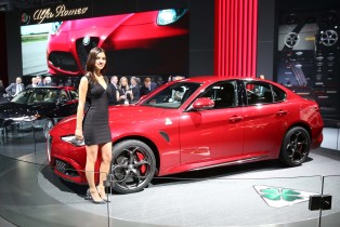 A model is next to the 2017 Alfa Romeo Giulia at the New York International Auto Show in New York on March 23, 2016. (Benjamin Chasteen/Epoch Times)
