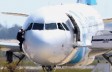 A man, leaves the hijacked aircraft of Egyptair from the pilot's window after landing at Larnaca airport Tuesday, March 29, 2016. (AP Photo/Petros Karadjias)