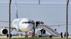 Passengers evacuate a hijacked EgyptAir Airbus 320 plane at Larnaca airport, Cyprus, March 29, 2016. REUTERS/Stringer