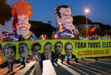 Workers of General Motors march against Brazil's President Dilma Rousseff,  former president Luiz Inacio Lula da Silva and oppositions as they carry inflatable dolls depicting Rousseff (L) and opposition senator Aecio Neves, near the GM plant in Sao Jose dos Campos, Brazil, March 18, 2016. The banner with pictures of (L-R)  Rousseff, Lula da Silva, senator Neves, Brazil's Vice President Michel Temer, senator Renan Calheiros and President of the Chamber of Deputies Eduardo Cunha, reads, "Out all of them, General Elections now!". REUTERS/Roosevelt Cassio       TPX IMAGES OF THE DAY     