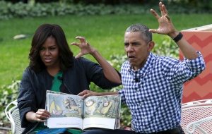 President Barack Obama and first lady Michelle Obama perform a reading of the children's book "Where the Wild Things Are" for children gathered for the annual White House Easter Egg Roll on the South Lawn of the White House in Washington, March 28, 2016. REUTERS/Yuri Gripas