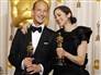 Image: Charles Ferguson and Audrey Marrs pose backstage with their Oscars for for Best Documentary Feature for the 'Inside Job