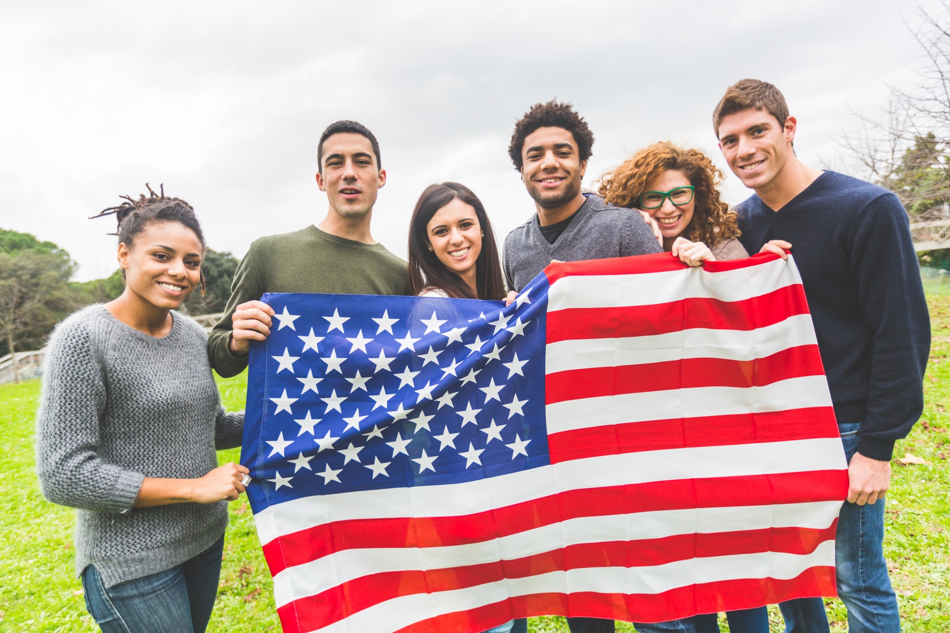 Group of people holding an American Flag