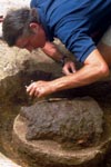 Archaeologist Eric Deetz uncovers a breastplate at the James Fort site