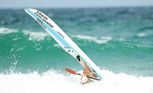 Former Yamba ironwoman Alyce Bennett cops the brunt of a wave in the ski leg of the Kellogg’s Nutri-Grain Ironwoman series event at Portsea on Sunday.