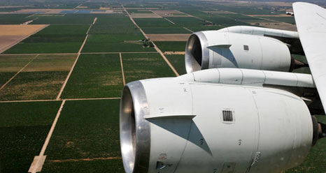 NASAs DC-8 airborne science laboratory flew low over San Joaquin Valley farm fields while specialized instruments collected data during the vegetation canopy and soil moisture study.