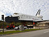 Shuttle model moves past guard shack