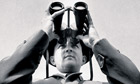 Peter Scott looking through binoculars