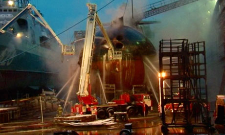 Firefighters spray water on the Yekaterinburg nuclear submarine