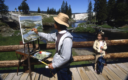 An artist paints on the bridge over the Firehole River near the Observation Point trail