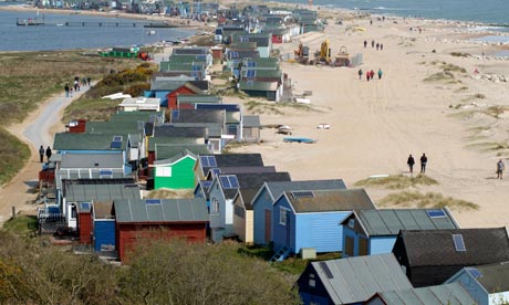 Mudeford Sandbank wooden beach houses with solar panels installed, in Dorset