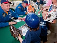 STS-134 astronauts Michael Fincke and Gregory Johnson threw out ceremonial opening pitches at Cleveland Indians' home game and signed autographs.