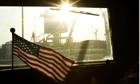 A guard stands on the border of Kuwait seen from the last US military convoy to leave Iraq