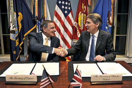 U.S. Defense Secretary Leon E. Panetta shakes hands with the United Kingdom's Secretary of State for Defense Philip Hammond after signing a statement of intent concerning enhanced cooperation on carrier operations and maritime power projection at the Pentagon, Jan. 5, 2012.