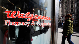 A customer walks out of a Walgreens store in New York City. 