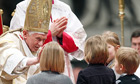 Pope Benedict XVI blesses children as he celebrates mass on New Year's Day in St Peter's