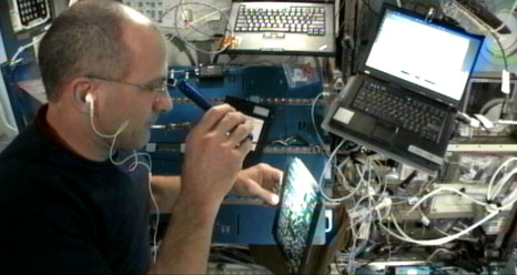 Astronaut Don Pettit examines computer card