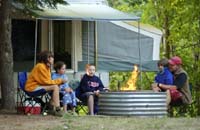 Family sitting around a campfire.