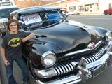 Photo: Ari Garnick in front of a car with campaign signs