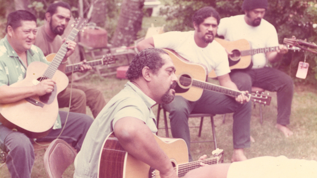 Gabby Pahinui (center), playing in his family's backyard with (from left to right) Leland "Atta" Isaacs, Philip Pahinui, Cyril Pahinui and Martin Pahinui. This photo is in the album insert for the 1972's Gabby.
