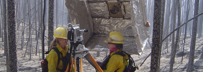 Rearchers set up equipment to monitor smoke emissions from smoldering fires.<br/>Photo Credit: PNW Research Station, US Forest Service