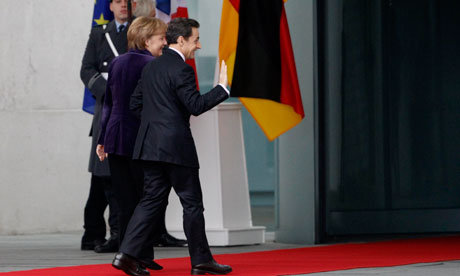 French President Sarkozy waves as he arrives to visit German Chancellor Merkel in Berlin