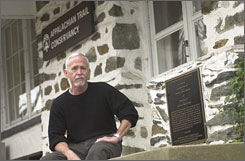 Dave Startzell, executive director of the Appalachian Trail Conservancy, sits in front of the Appalachian Trail Conservancy Office in Harpers Ferry, W.Va.