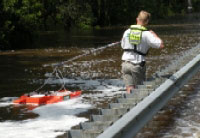 USGS hydrologic technician Erik Ohlson measures the discharge of the Suwannee River floodwaters coming over US highway 90 near Ellaville, Florida. (Saturday, April 11, 2009)