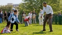 The President cheers on children rolling Easter eggs