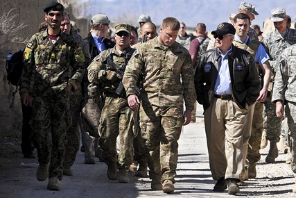 U.S. Defense Secretary Robert M. Gates speaks with U.S. Army 1st Lt. Mike Viti, an International Security Assistance Force member and platoon leader, on Combat Outpost Kowall in Afghanistan, March 8, 2011.