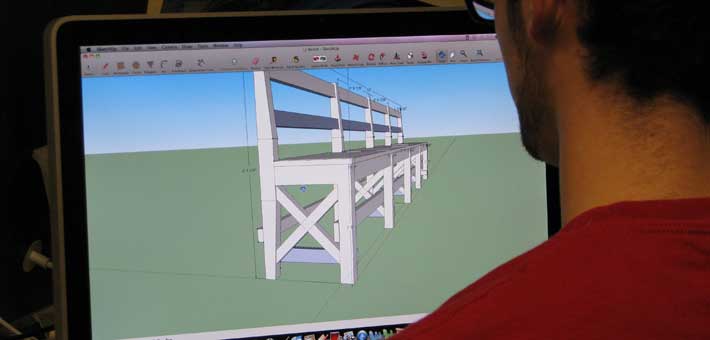 Photo of a student from Campbell-Savona High Schools designing a bench for Ellis Island 