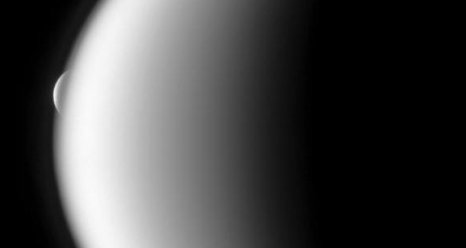 In a dramatic example of occultation, a Saturn moon, Rhea, emerges after being occulted by the larger moon Titan.