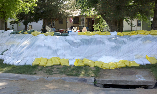 Photo: Finished 4 and 1/2 foot tall sandbag dike along bend in Suncoast Drive.
