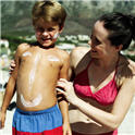 mother and sun with sunscreen lotion