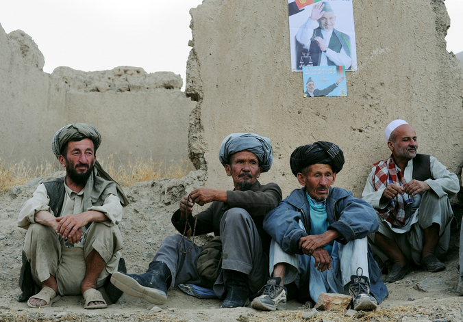 Supporters wait for Afghan President Hamid Karzai to arrive at a rally in Dar-e-Kayan, Afghanistan.