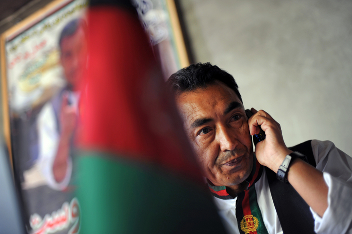 Afghan presidential candidate Ramzan Bashardost, former minister of planning and current member of Parliament, takes a phone call in Kabul, Afghanistan. Bashardost's campaign office is a single tent pitched across the street from the Afghan Parliament.