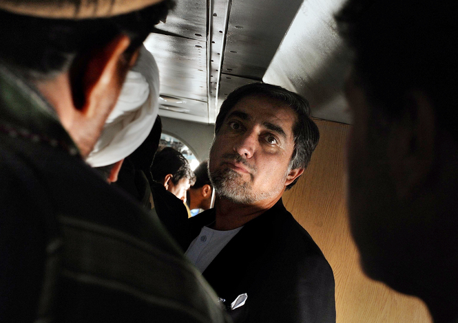 Afghan presidential candidate Abdullah Abdullah, center, arrives on an old Russian aircraft for a rally in Maymana, Afghanistan.