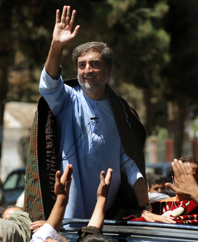 Afghan presidential candidate Abdullah Abdullah waves to supporters as he leaves a rally in Maymana, Afghanistan.