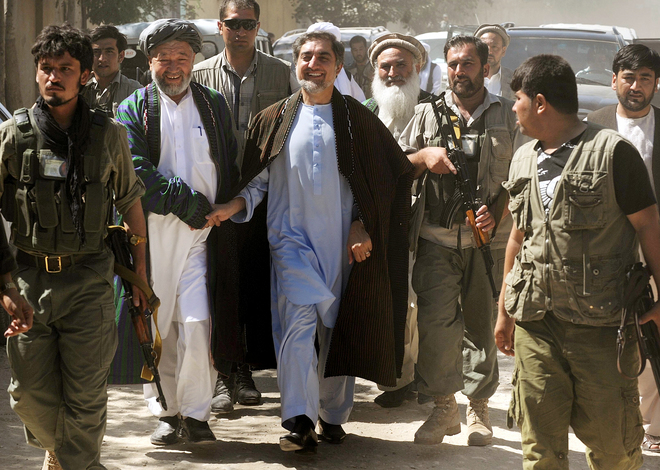 Afghan presidential candidate Abdullah Abdullah, center, is greeted by a tribal elder in Maymana,  Afghanistan.