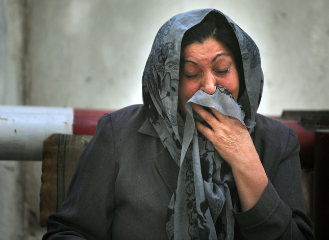 A woman cries as she waits for news of her husband's health after a bomb exploded outside the NATO headquarters in Kabul.