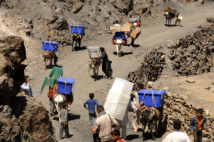 Men guide their donkeys carrying election supplies in the rugged mountains of the Panjshir Valley.   Afghan officials dispatched donkey trains into mountains laden with ballot boxes and voting papers, taking material for landmark elections to the most remote communities. 